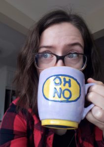 R. Conway, drinking from a mug that says "OH NO"