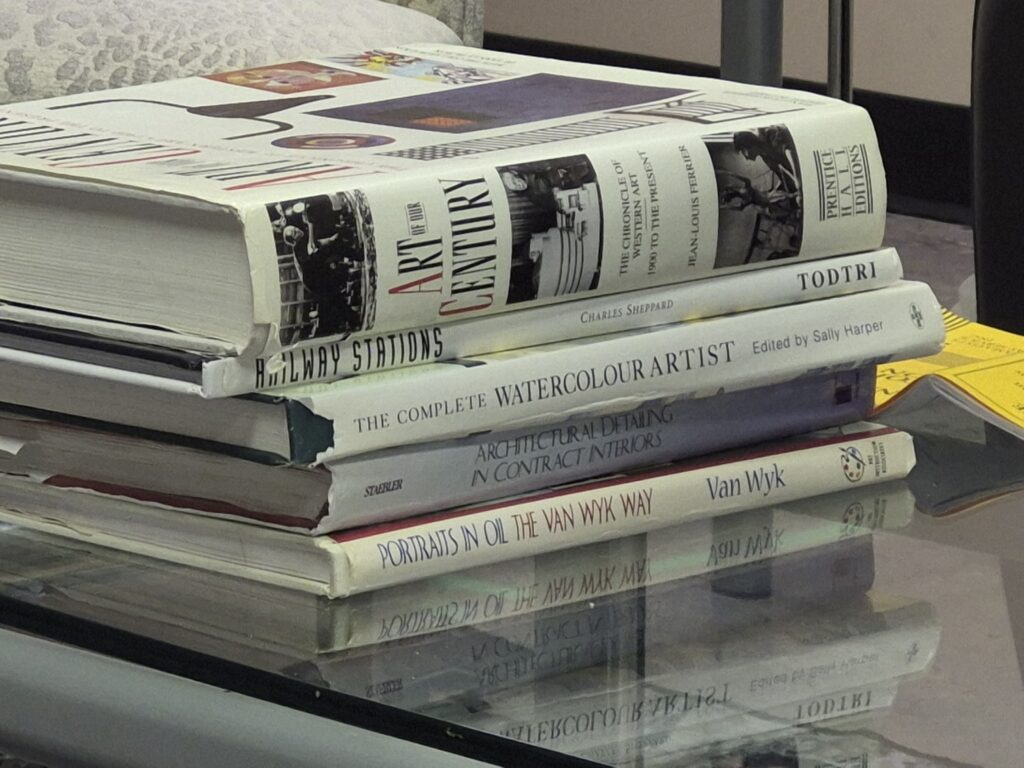 A stack of books about art and architecture, lying on a coffee table. They look very impressive, these people must be really smart and cultured.
